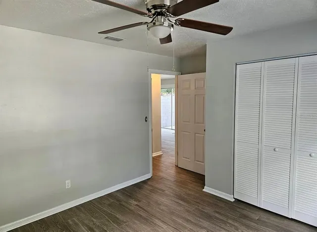 a view of an empty room and wooden floor