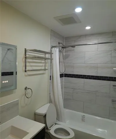 a bathroom with a shower a toilet and a sink