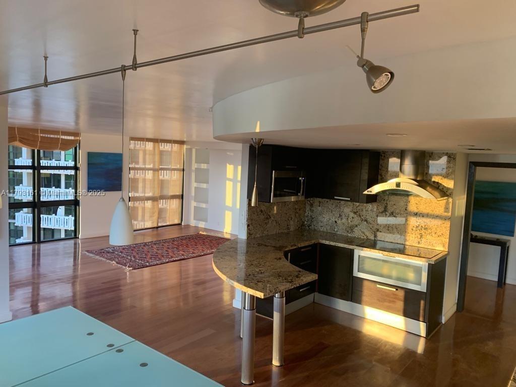 1121 Crandon Boulevard, Unit D802 Key Biscayne, FL 33149 - Photo 14 of 30 a living room with furniture and a chandelier