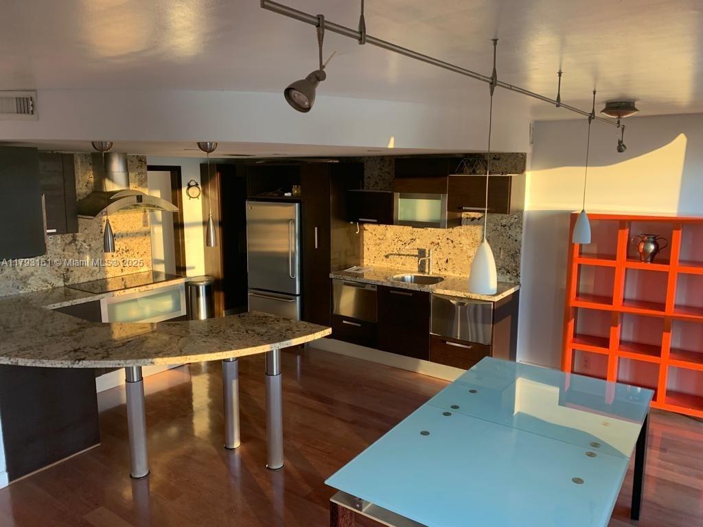 1121 Crandon Boulevard, Unit D802 Key Biscayne, FL 33149 - Photo 17 of 30 a kitchen with stainless steel appliances granite countertop a sink and a microwave