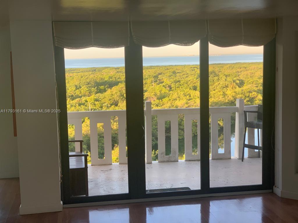 1121 Crandon Boulevard, Unit D802 Key Biscayne, FL 33149 - Photo 18 of 30 a view of a living room with large windows