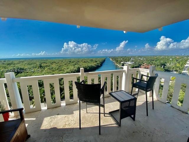 1121 Crandon Boulevard, Unit D802 Key Biscayne, FL 33149 - Photo 2 of 30 a view of a chairs and table in patio