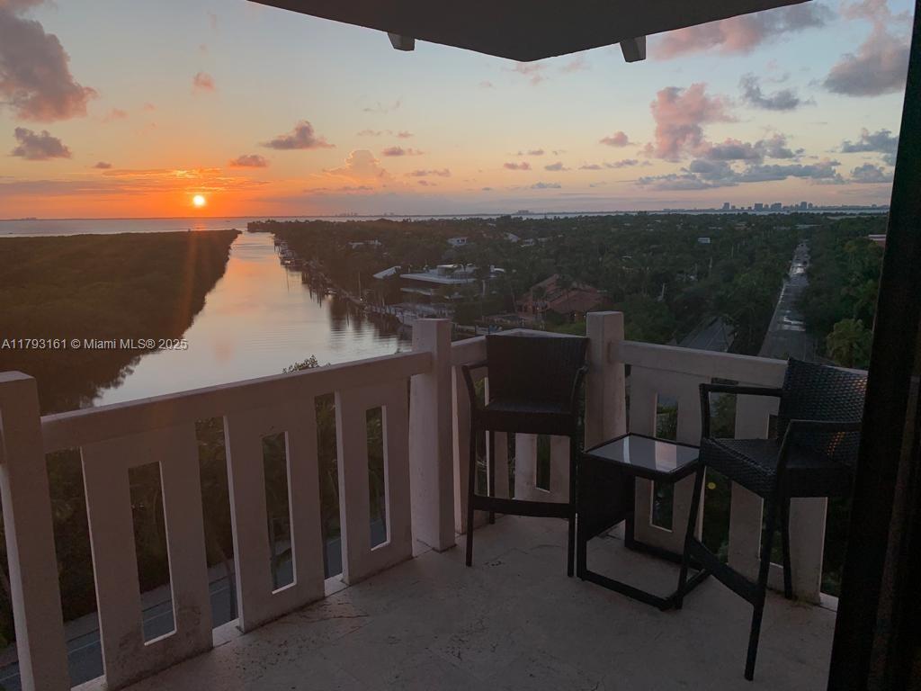 1121 Crandon Boulevard, Unit D802 Key Biscayne, FL 33149 - Photo 22 of 30 a view of a chairs and table in patio