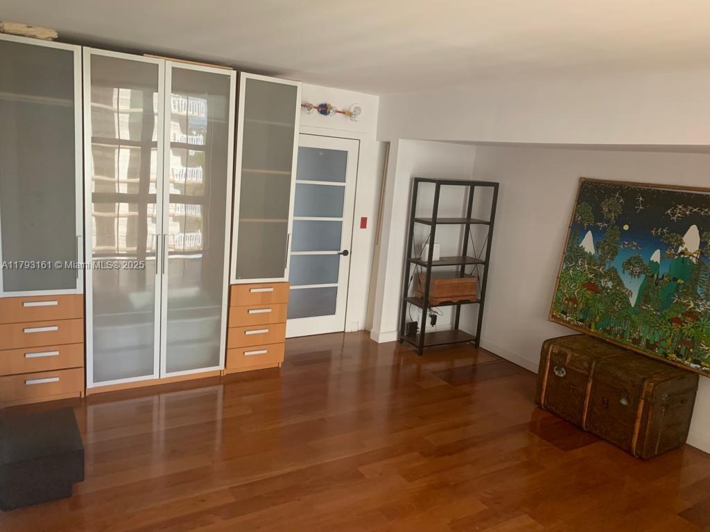 1121 Crandon Boulevard, Unit D802 Key Biscayne, FL 33149 - Photo 26 of 30 a view of an empty room with window and wooden floor