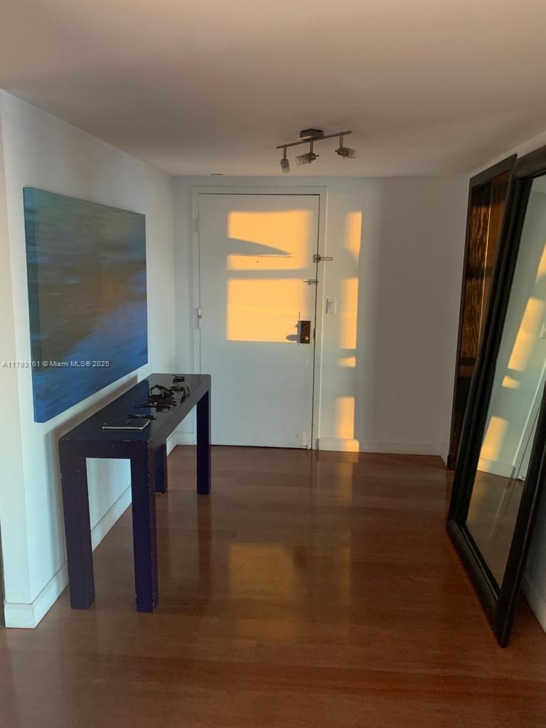 1121 Crandon Boulevard, Unit D802 Key Biscayne, FL 33149 - Photo 27 of 30 a view of an empty room with wooden floor and a window