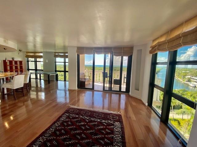 1121 Crandon Boulevard, Unit D802 Key Biscayne, FL 33149 - Photo 5 of 30 a large hall with wooden floor and a rug