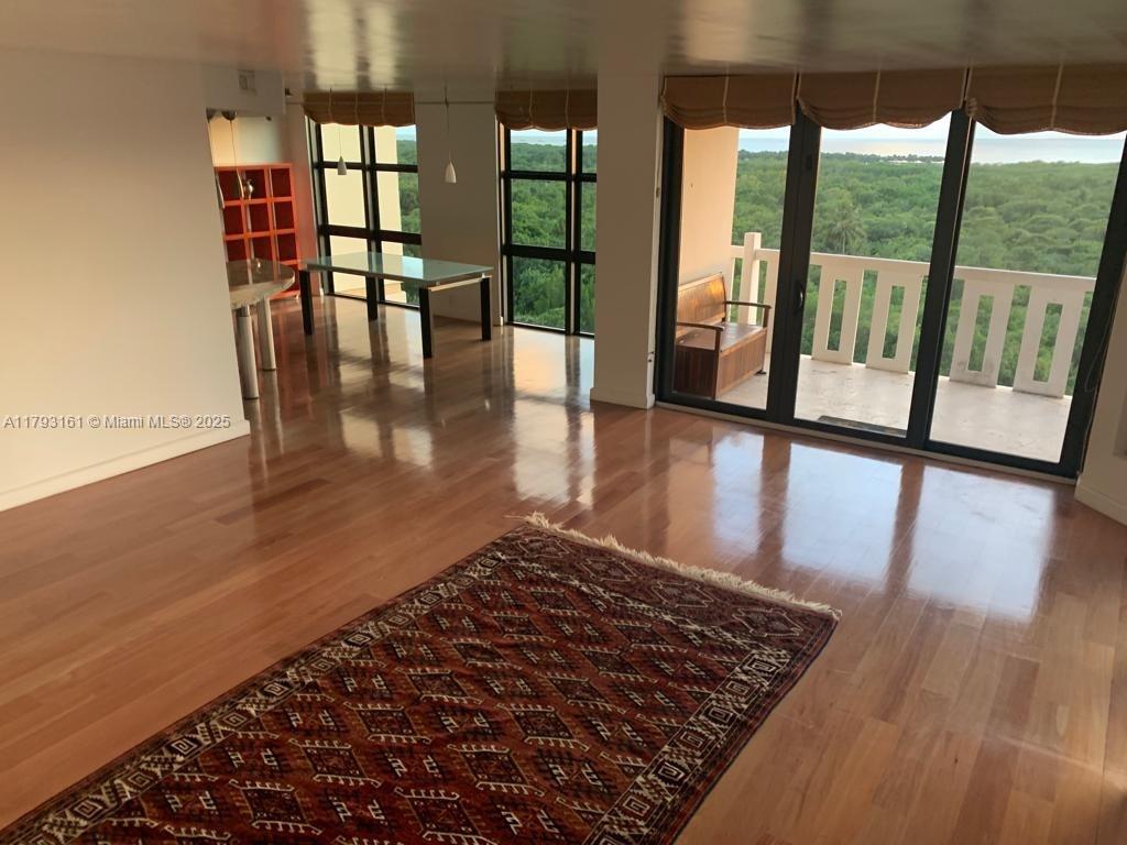 1121 Crandon Boulevard, Unit D802 Key Biscayne, FL 33149 - Photo 7 of 30 wooden floor in an empty room with glass door