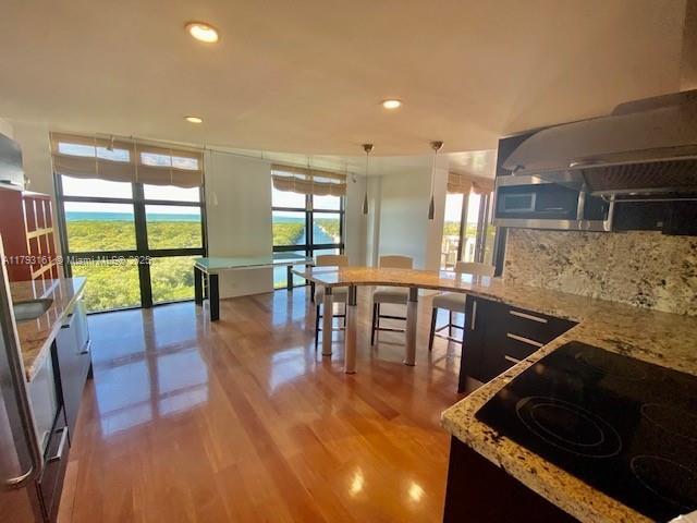 1121 Crandon Boulevard, Unit D802 Key Biscayne, FL 33149 - Photo 8 of 30 a kitchen with stainless steel appliances granite countertop a stove and a view of living room