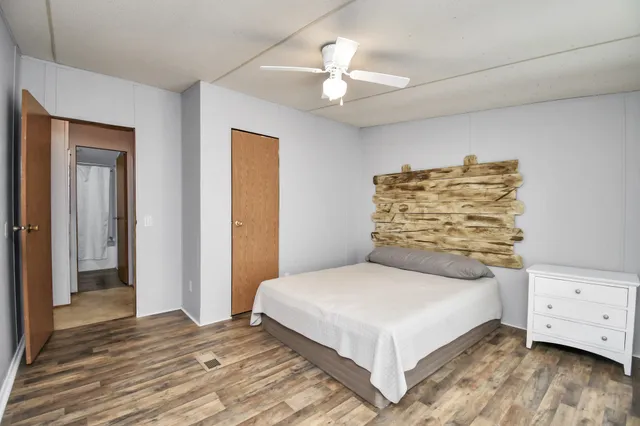 a bedroom with a bed and a chandelier