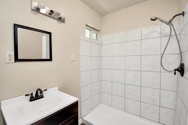 a view of a kitchen with a sink and a refrigerator