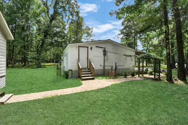 a view of a chair and table in backyard of the house