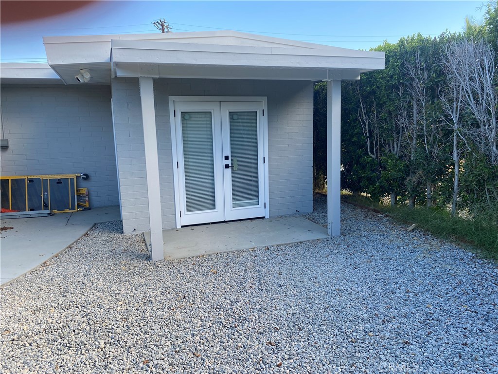 a view of a house with a backyard and trees