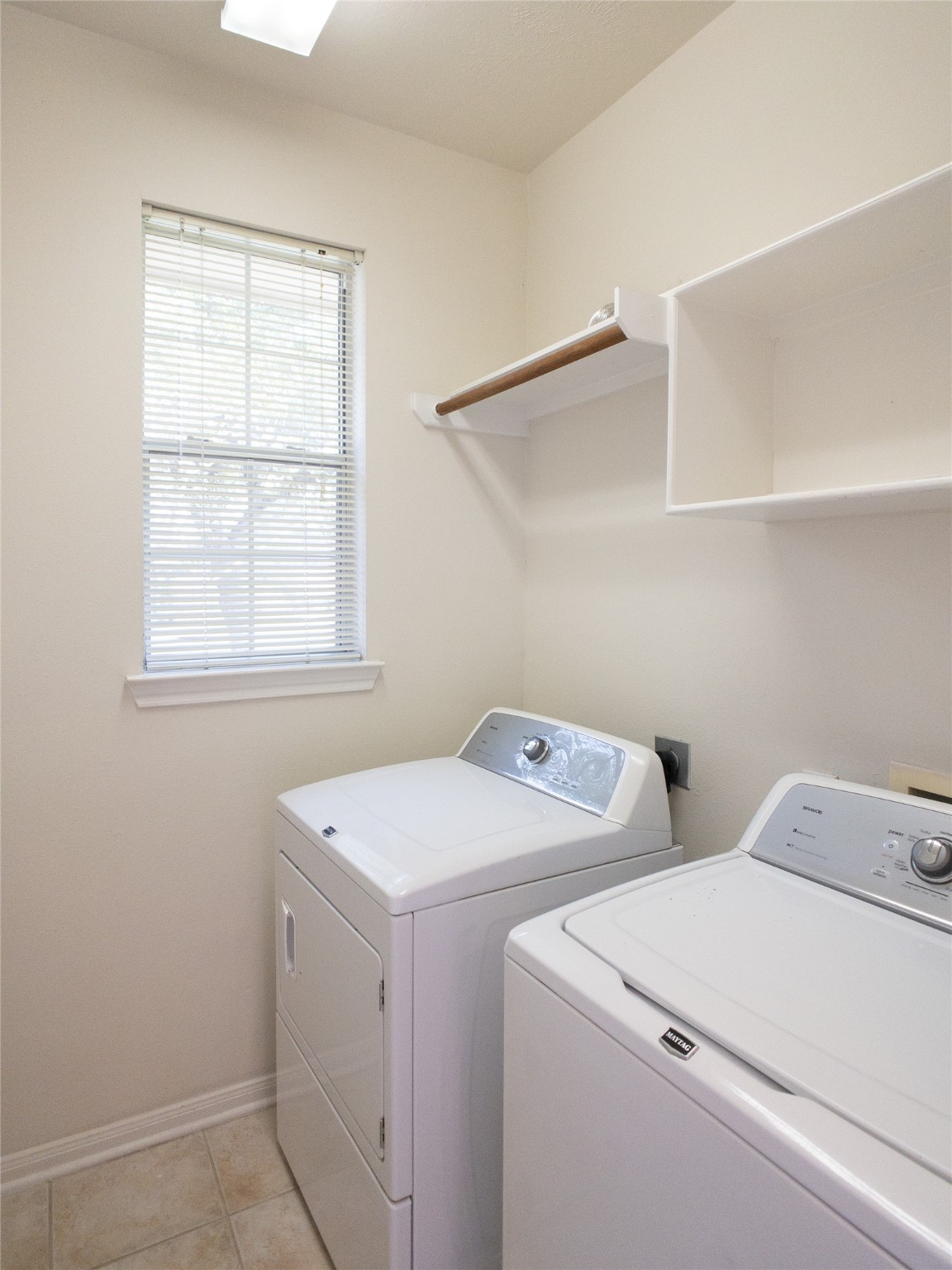 2727 South Cedar Hollow Drive Pearland, TX 77584 - Photo 13 of 41 spacious laundry room with washer & dryer, shelving, and hanging rod
