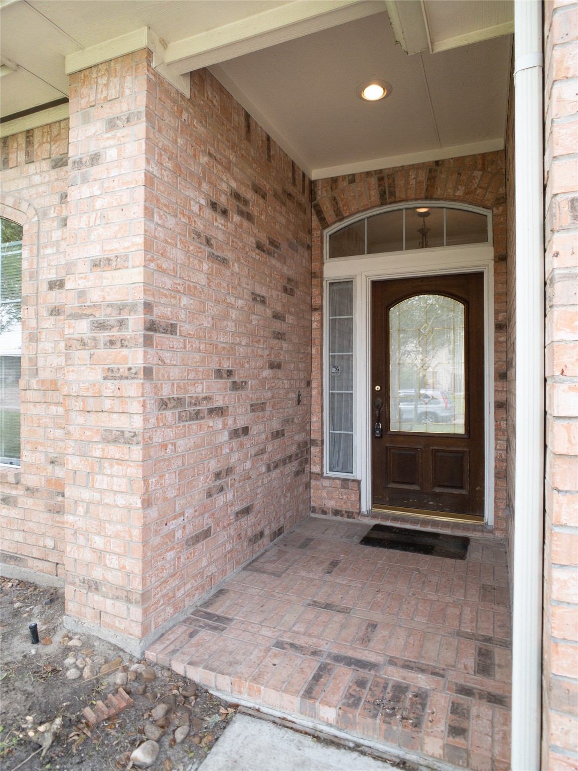 2727 South Cedar Hollow Drive Pearland, TX 77584 - Photo 3 of 41 covered brick front porch with elegant glass & wood front door, featuring transom window & sidelight