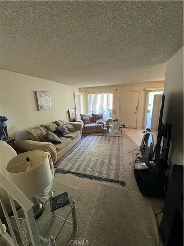 a view of a livingroom with furniture and a window