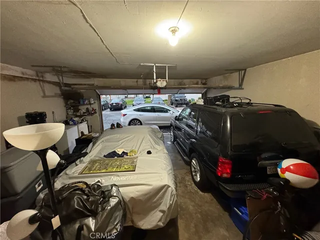a kitchen with granite countertop stainless steel appliances a sink and a refrigerator