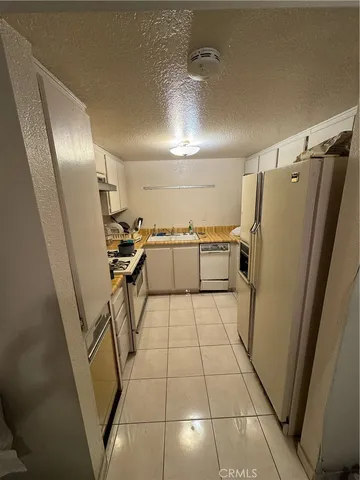 a kitchen with a stove a sink and a refrigerator