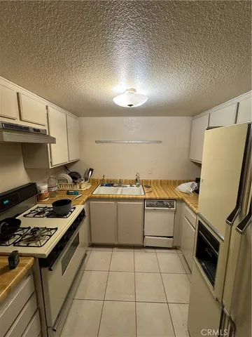 a kitchen with a sink and refrigerator