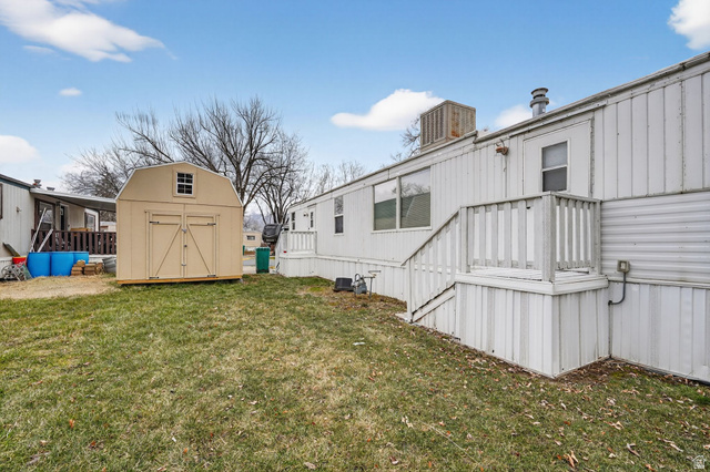 24 Grover Street Layton, UT 84041 - Photo 6 of 21 View of green lawn featuring a storage unit