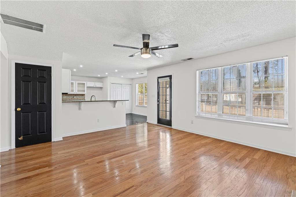 3550 Willow Tree Trace Decatur, GA 30034 - Photo 14 of 47 a view of an empty room with a window and wooden floor