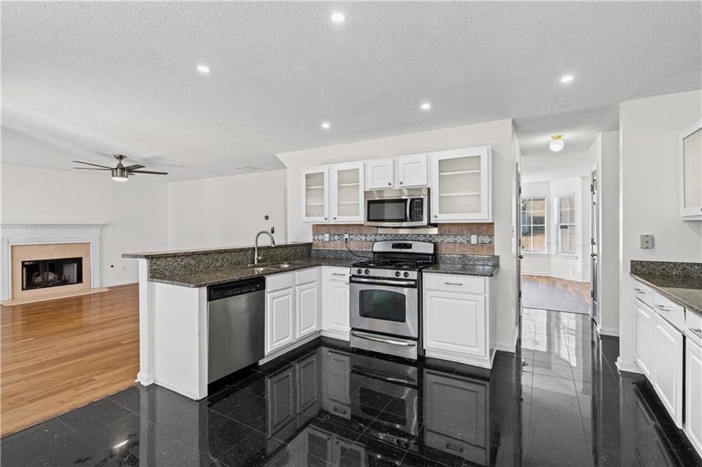 3550 Willow Tree Trace Decatur, GA 30034 - Photo 20 of 47 a kitchen with stainless steel appliances granite countertop a stove refrigerator sink and microwave