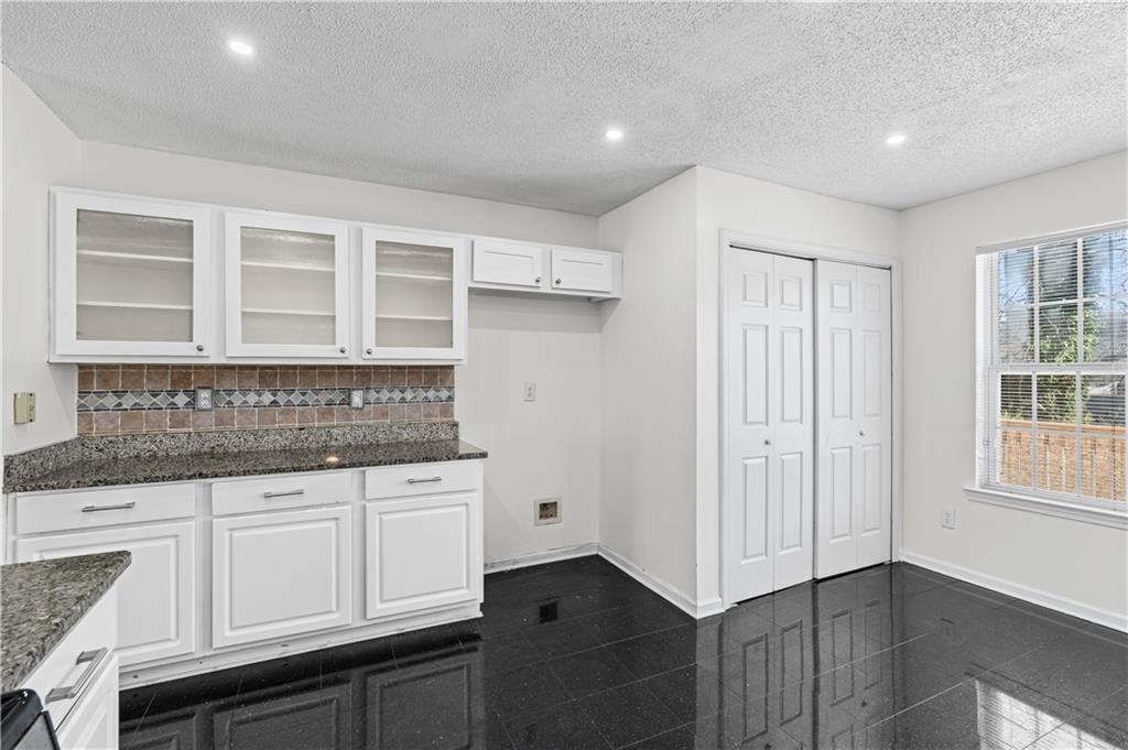 3550 Willow Tree Trace Decatur, GA 30034 - Photo 24 of 47 a kitchen with granite countertop white cabinets and sink