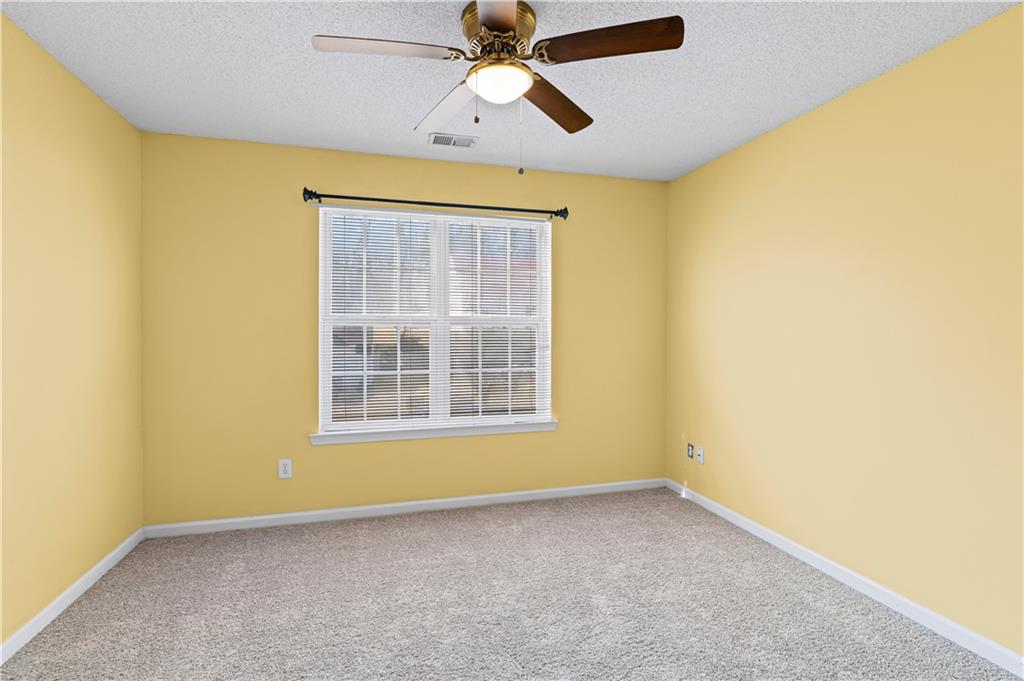3550 Willow Tree Trace Decatur, GA 30034 - Photo 36 of 47 an empty room with a window and a ceiling fan
