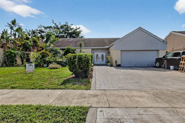 a front view of a house with a yard and a garage