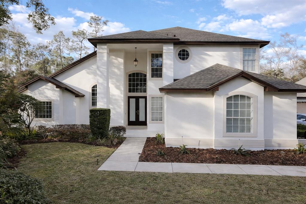 9285 Wickham Way Orlando, FL 32836 - Photo 1 of 1 a front view of a house with a yard