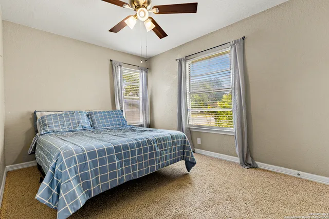 a bedroom with a bed and window