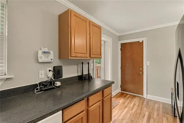 a view of kitchen with a sink wooden floor and staircase