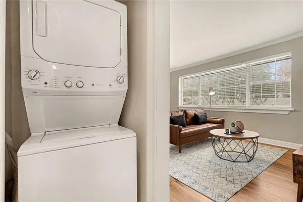 a view of washer and dryer with bathroom in the background
