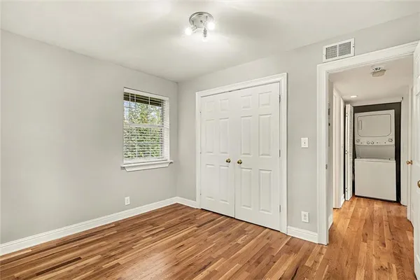 a view of a room with wooden floor and window