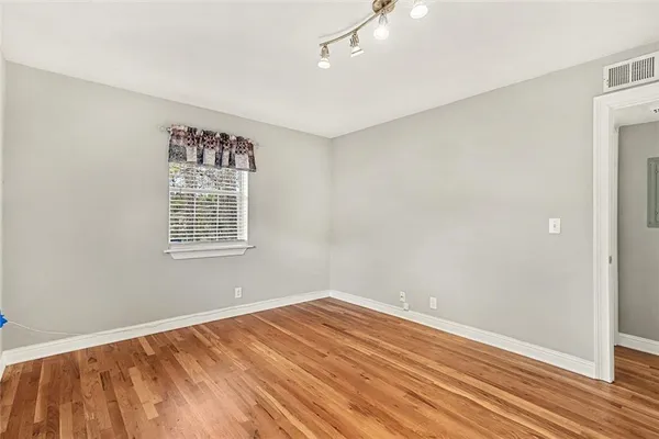 wooden floor in an empty room with a window