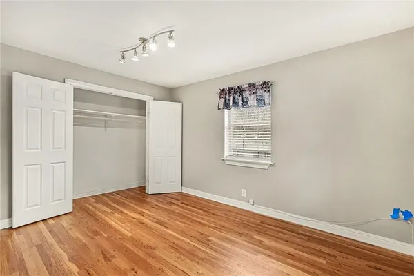 a view of a room with wooden floor and bathroom