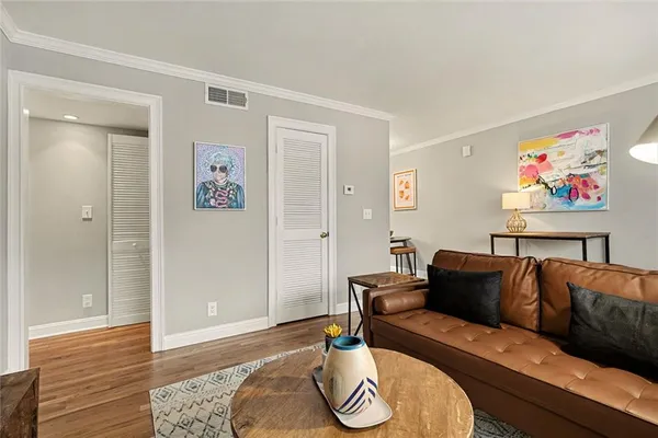 a living room with furniture and wooden floor