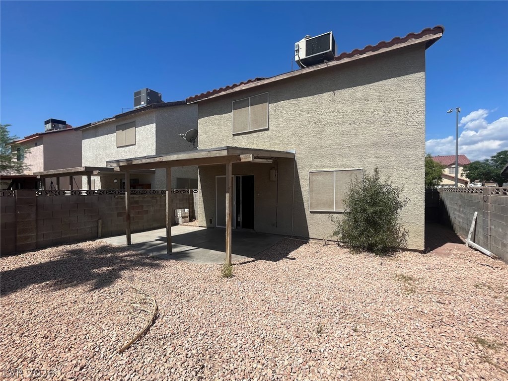 914 Scarlet Ridge Drive Las Vegas, NV 89128 - Photo 15 of 25 A spacious backyard with a covered patio offers ample room for relaxation and outdoor activities.