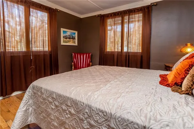 a bedroom with a large bed and a chandelier