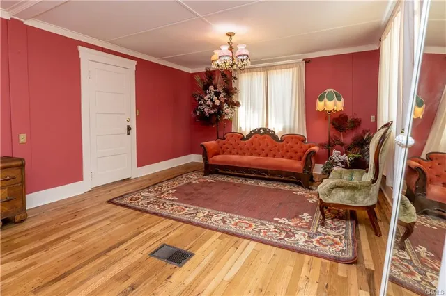 a spacious bedroom with a large bed and a chandelier