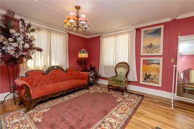 a bedroom with a bed and ceiling chandelier