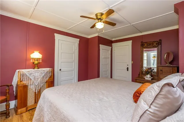 a dining room with furniture a chandelier and wooden floor
