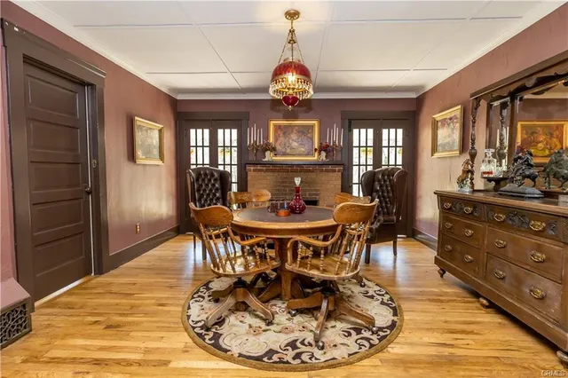 a dining room with furniture a chandelier and wooden floor