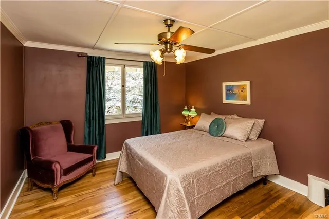 a bedroom with a bed table and a potted plant