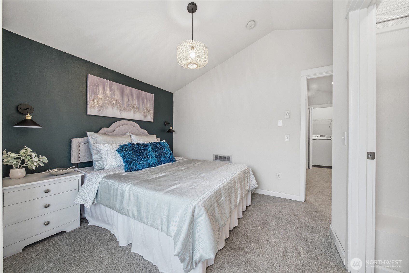 1122 North 92nd Street, Unit B Seattle, WA 98103 - Photo 14 of 28 a bedroom with a bed and a chandelier