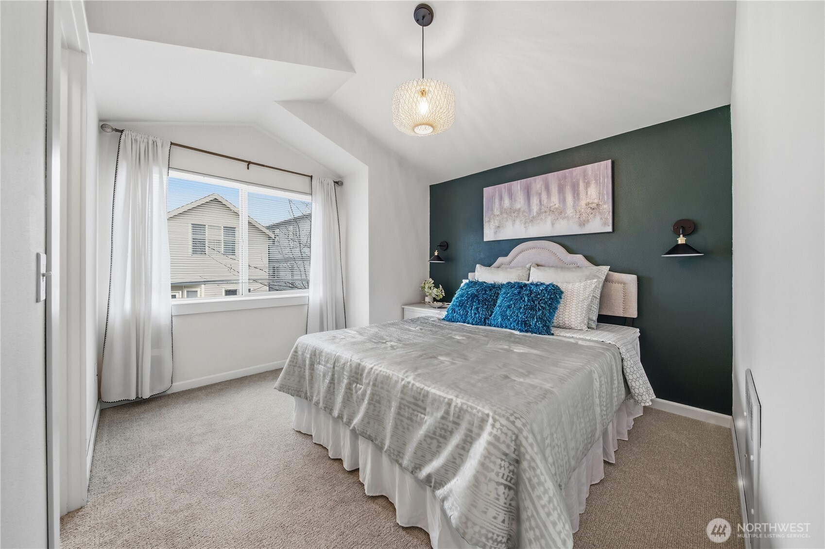 1122 North 92nd Street, Unit B Seattle, WA 98103 - Photo 15 of 28 a bedroom with a large bed and a chandelier