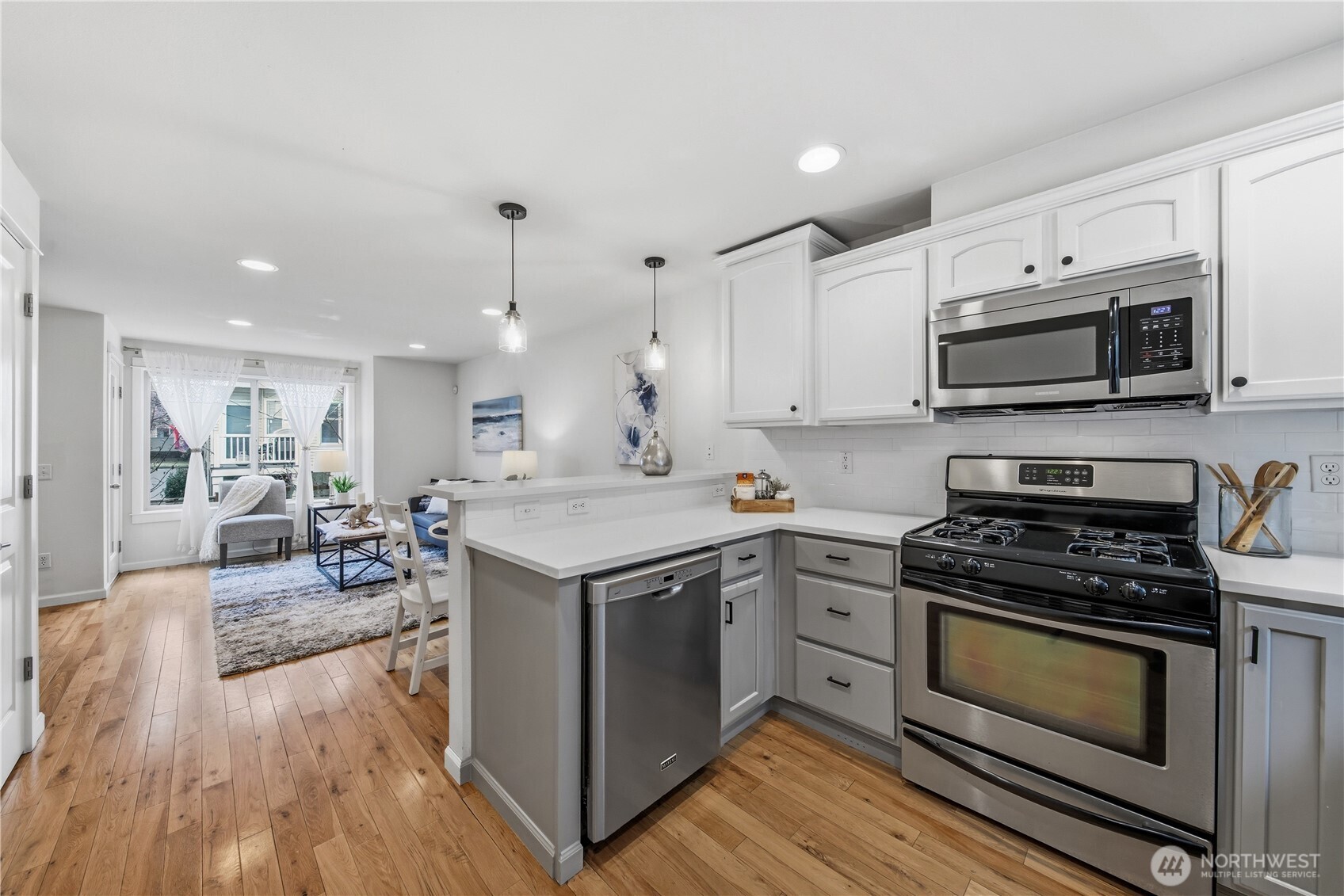 1122 North 92nd Street, Unit B Seattle, WA 98103 - Photo 4 of 28 a kitchen with a stove and a microwave