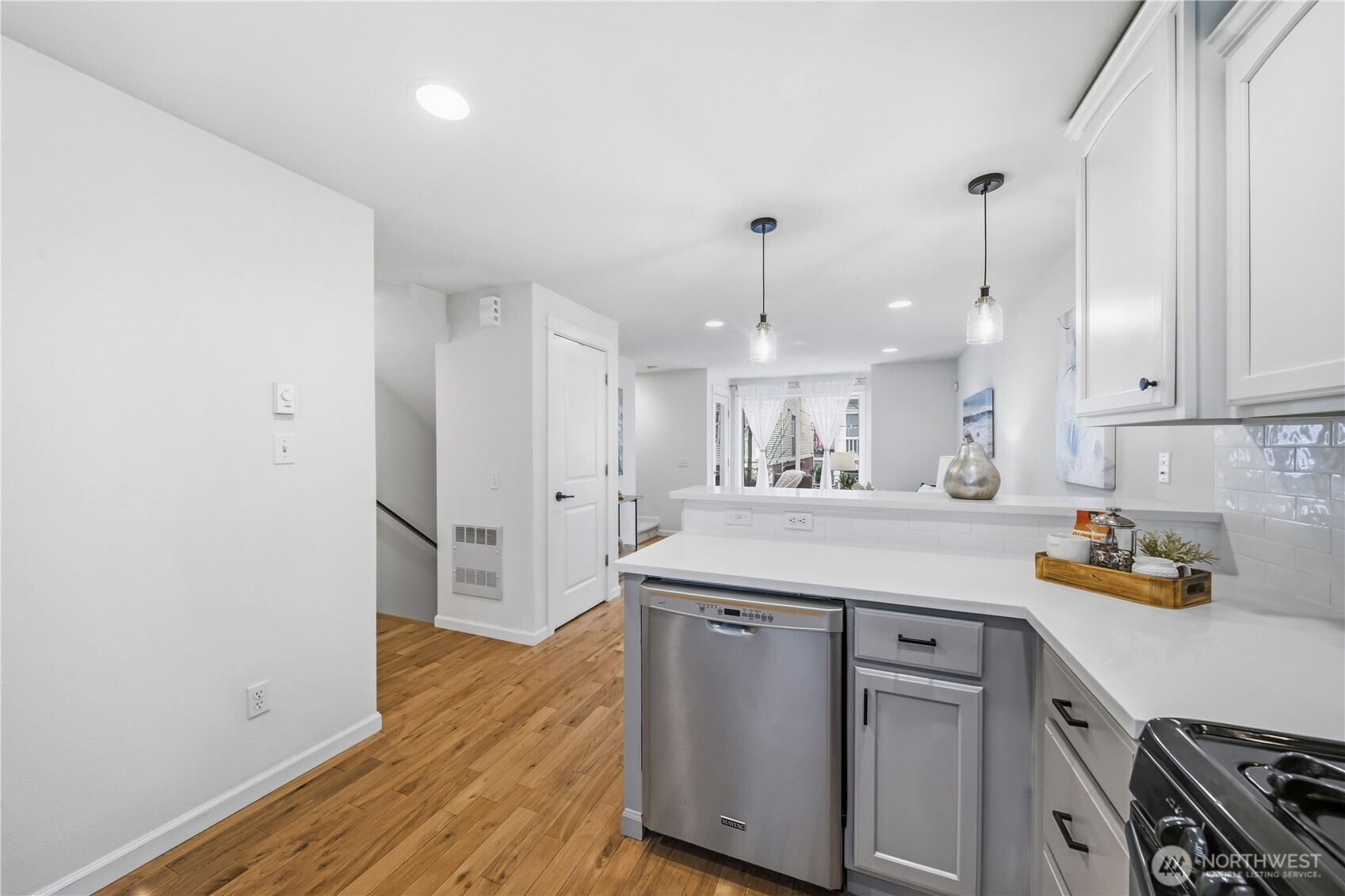 1122 North 92nd Street, Unit B Seattle, WA 98103 - Photo 6 of 28 a kitchen with a refrigerator a sink and wooden floor