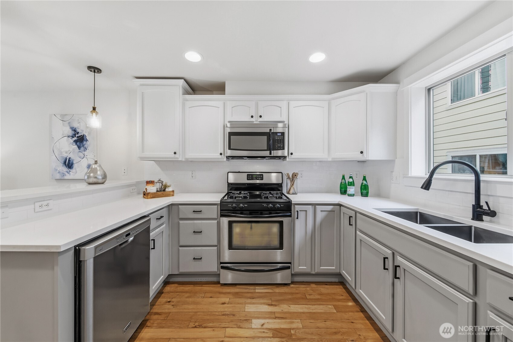 1122 North 92nd Street, Unit B Seattle, WA 98103 - Photo 7 of 28 a kitchen with cabinets appliances and a sink