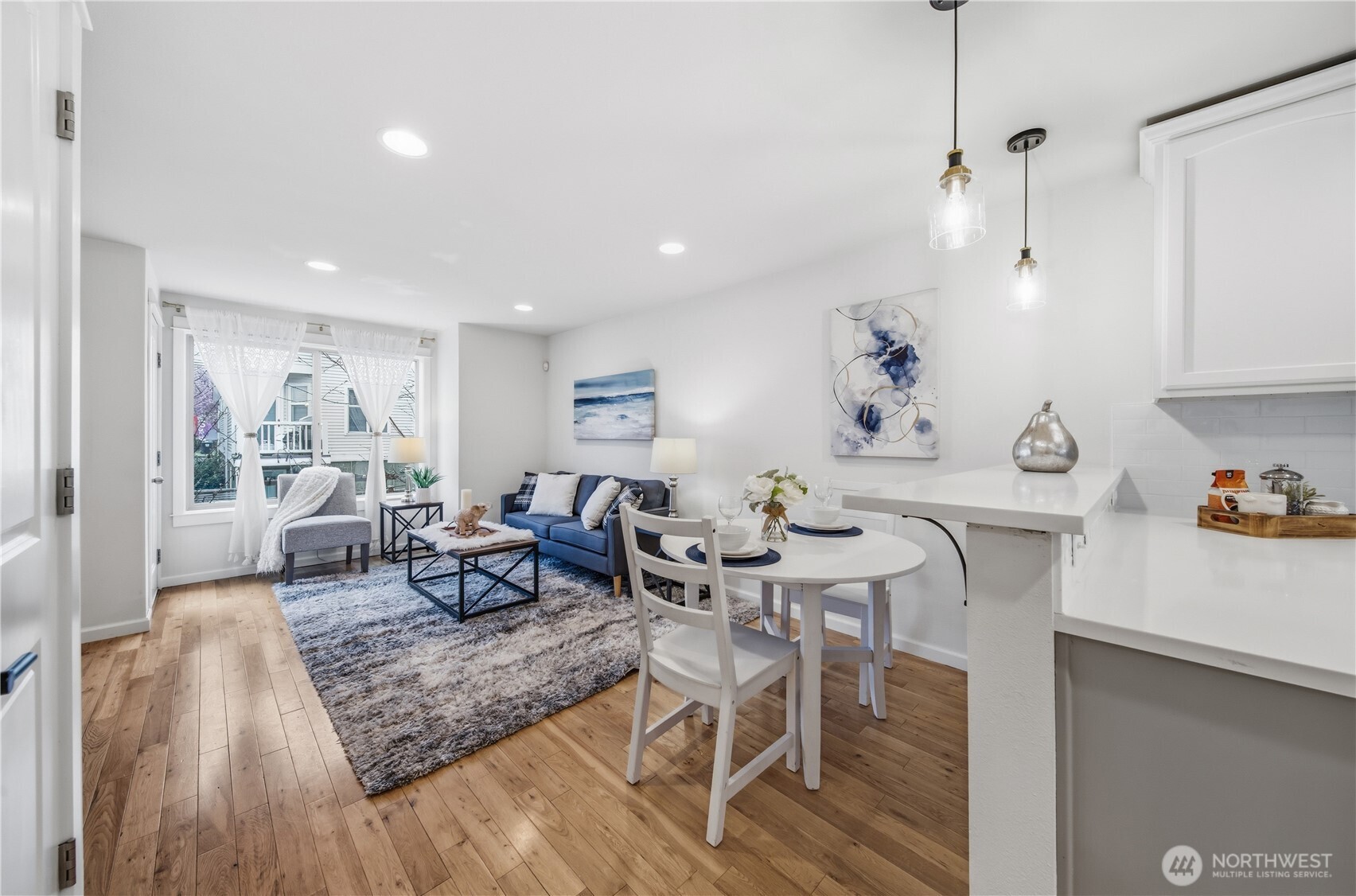 1122 North 92nd Street, Unit B Seattle, WA 98103 - Photo 9 of 28 a living room with furniture and wooden floor