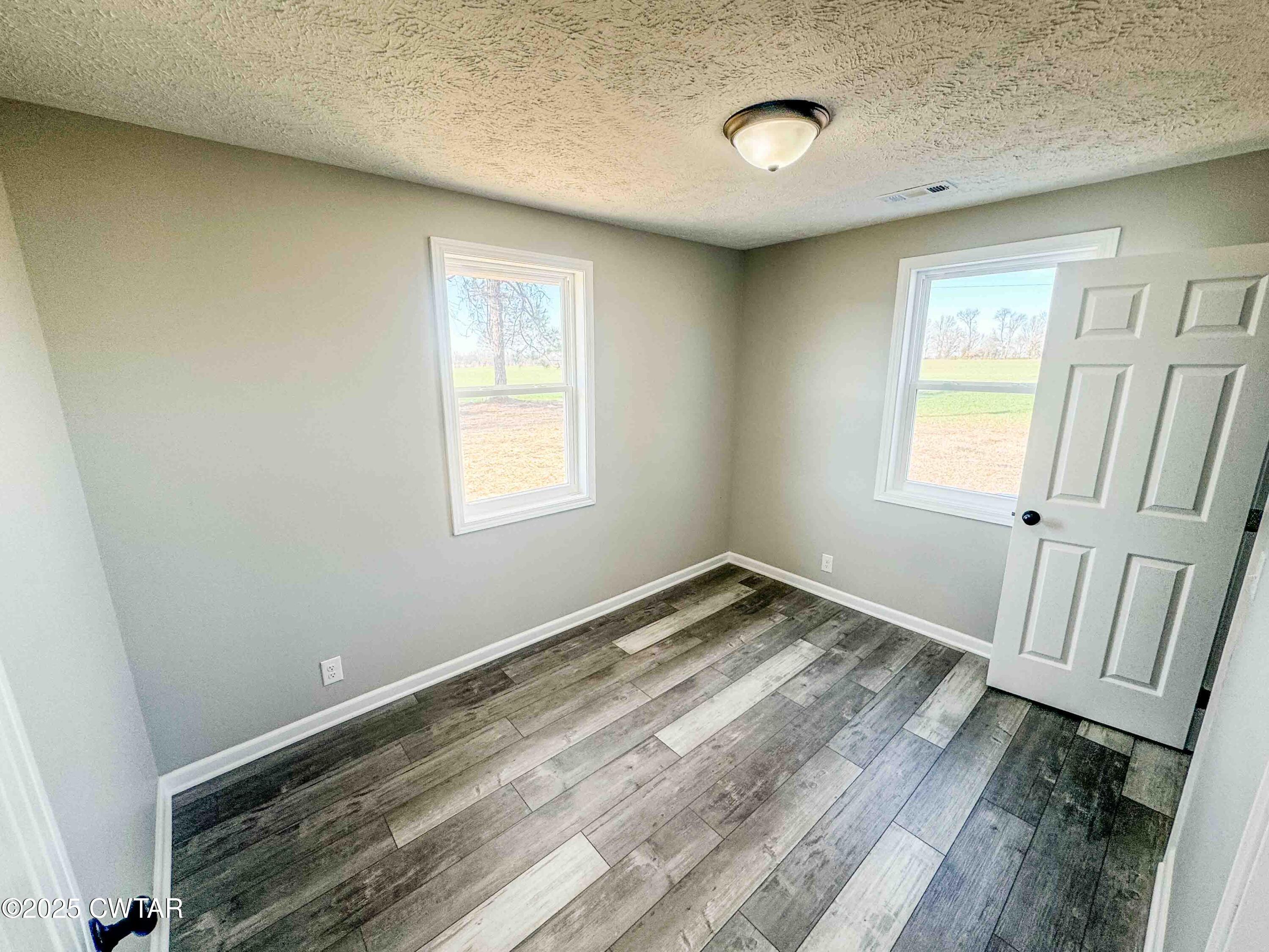 27 Watson Road Dyer, TN 38330 - Photo 11 of 17 a view of a room with wooden floor and window